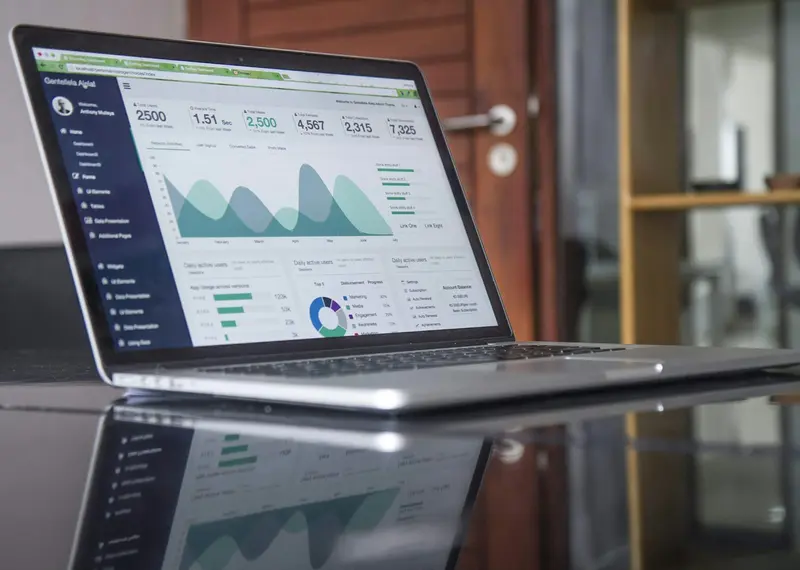Laptop displaying analytics dashboard with charts and data